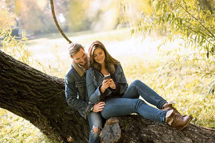 Couple Sitting Together Under Tree