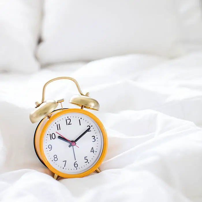 Clock sitting on bed | Time management tips for non-planner users