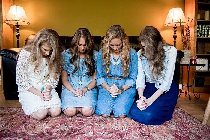 Women Kneeling Together in Prayer